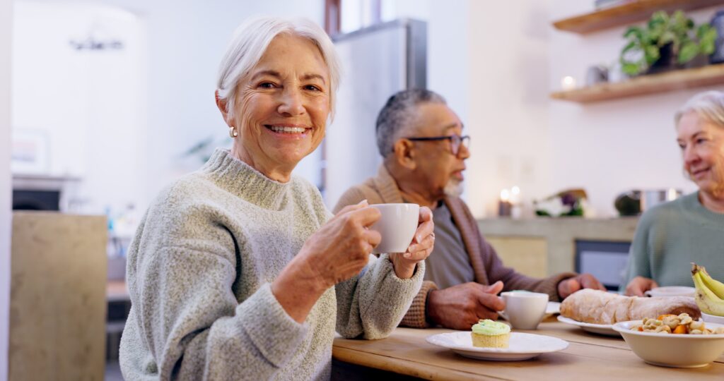 Senior living residents enjoying coffee at breakfast